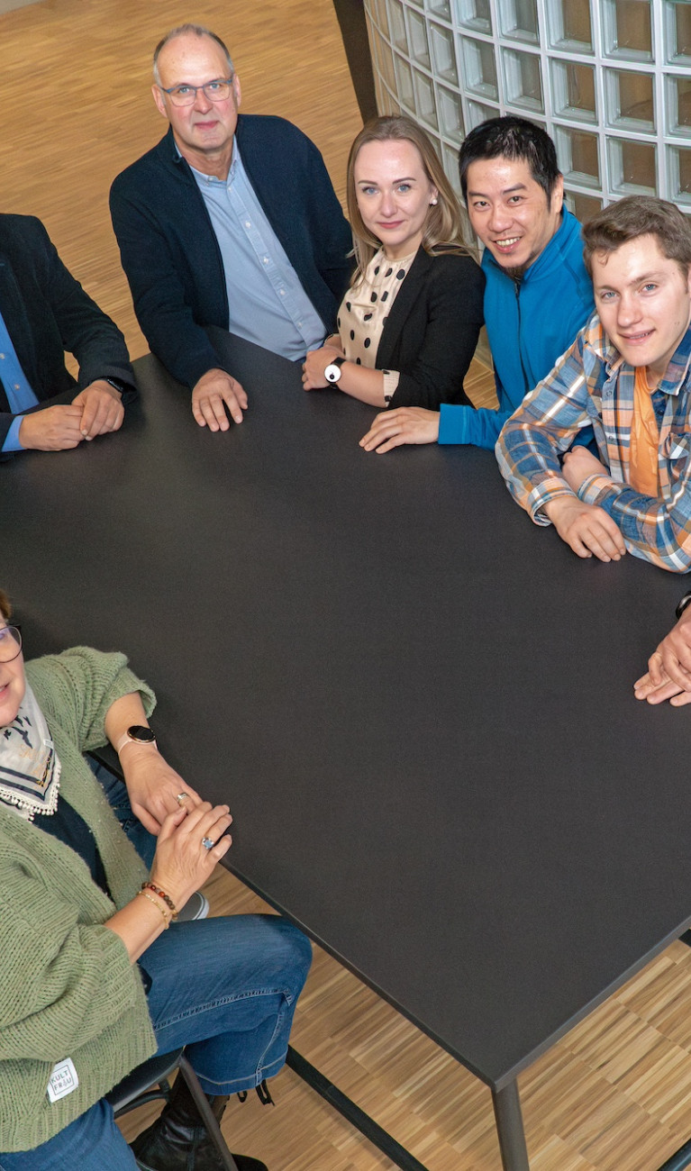 Gruppenbild mit 10 Personen rund um einen Tisch